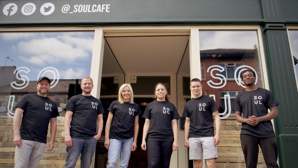 The MJK team pictured outside the Soul Cafe