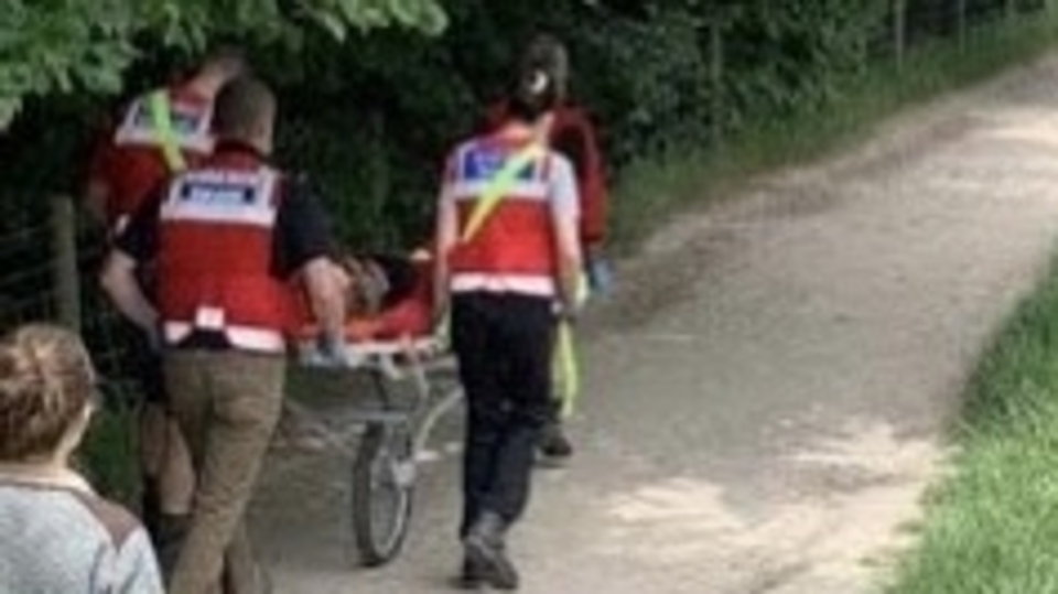 The injured girl is helped to safety The injured girl is helped to safety