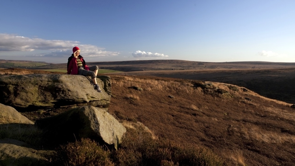 A walker takes a rest to admire the South Pennine's unique landscape A walker takes a rest to admire the South Pennine's unique landscape