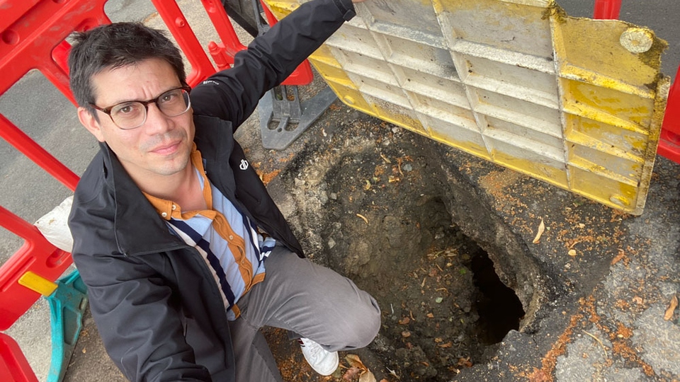 Councillor Sam Al-Hamdani pictured at the scene of the hole in the street