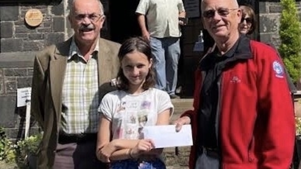 Rescue Team doctor Andy Taylor receives a cheque for £1,122.79 from Lay Minister Duncan Ross and Harvest Queen Amelie Betts Rescue Team doctor Andy Taylor receives a cheque for £1,122.79 from Lay Minister Duncan Ross and Harvest Queen Amelie Betts
