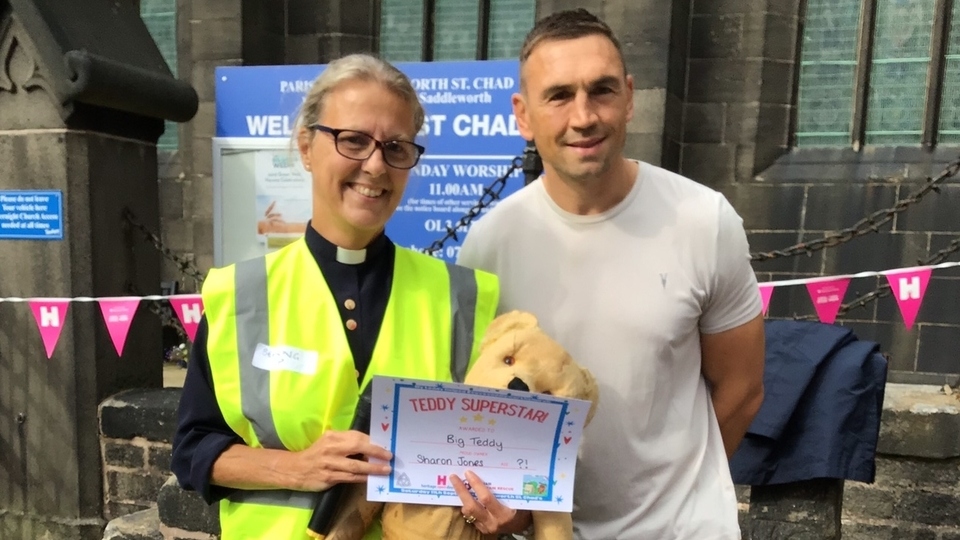 Superhero teddy with  his owner Canon Sharon Jones and sporting legend Kevin Sinfield.