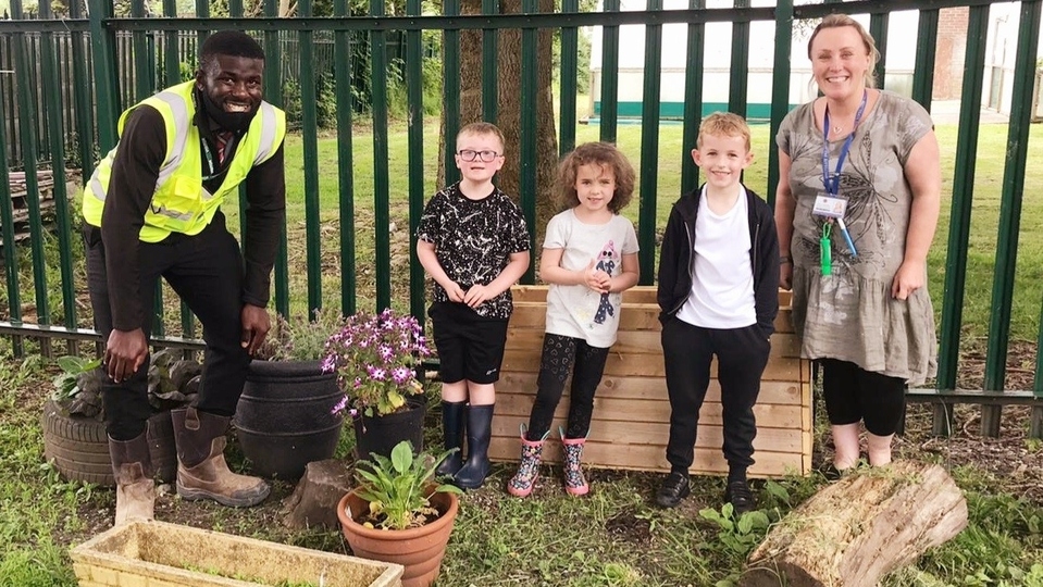 Redrow's Obi Ebizie with children and Cathy MacMillan from Whitegate End Primary