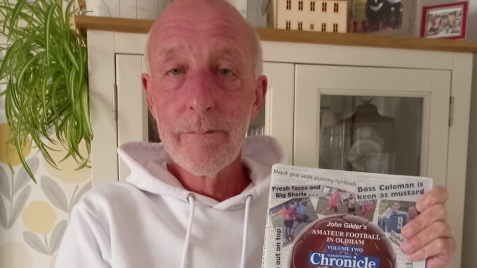 Former Oldham Chronicle amateur football specialist John Gilder with his latest book Former Oldham Chronicle amateur football specialist John Gilder with his latest book