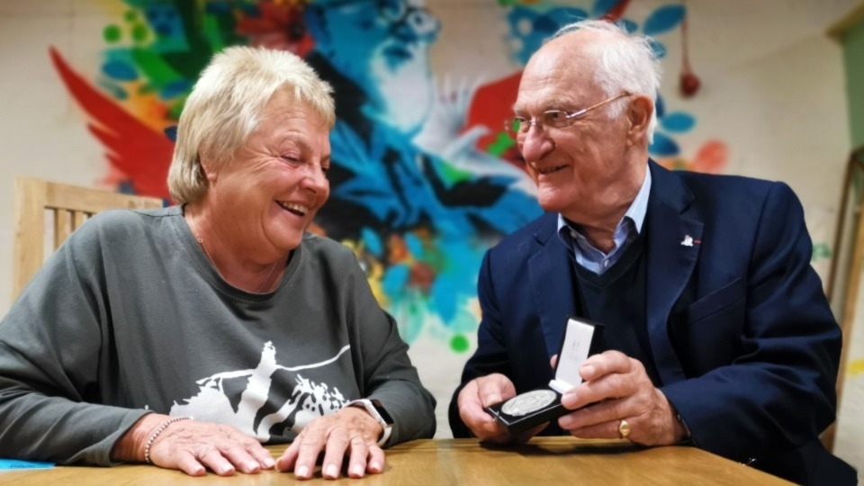 Emmaus Mossley President Ann Thorne receives her medal from Selwyn Image CBE, Vice Chair of Emmaus UK