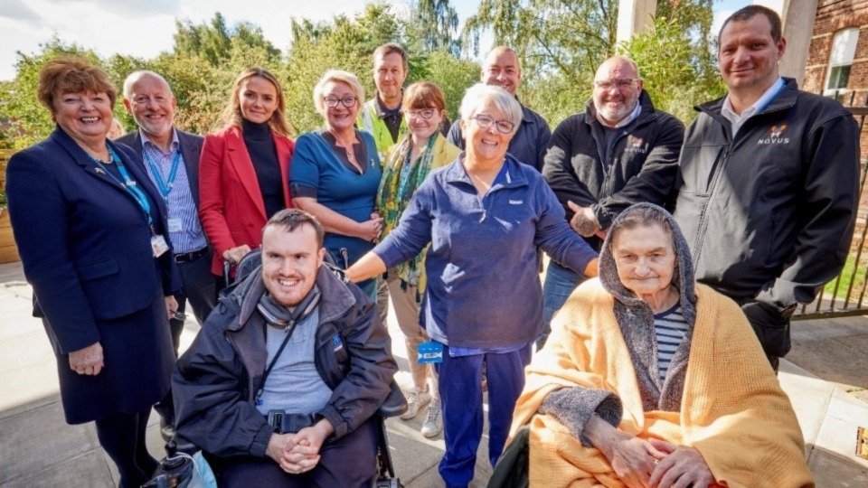 Victor, front right, is joined by Allison Keegan, Advanced Care Practitioner (centre) representatives of Novus, Morgan Sindall Group, Kathy Cowell OBE, Chairman of MFT (far left) who is next to Chief Executive of North Manchester General Hospital Ian Lurcock