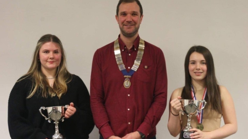 Amy Jakeman and Millie Foster are pictured flanking John Arthurs