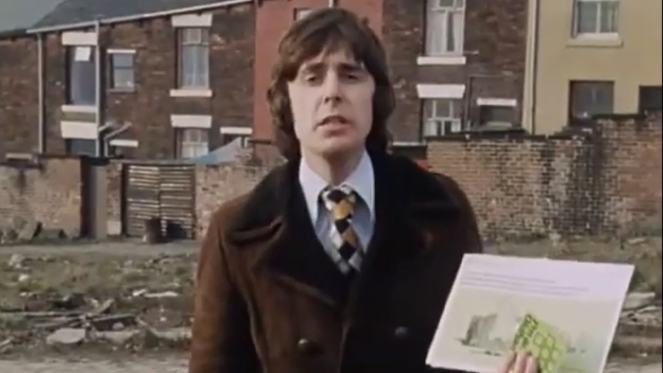 John Stapleton with a 'glossy brochure' John Stapleton with a 'glossy brochure'