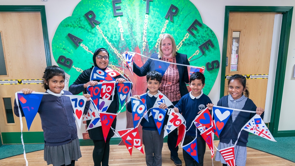 Councillor Chadderton with children from Bare Trees Primary School and their bunting