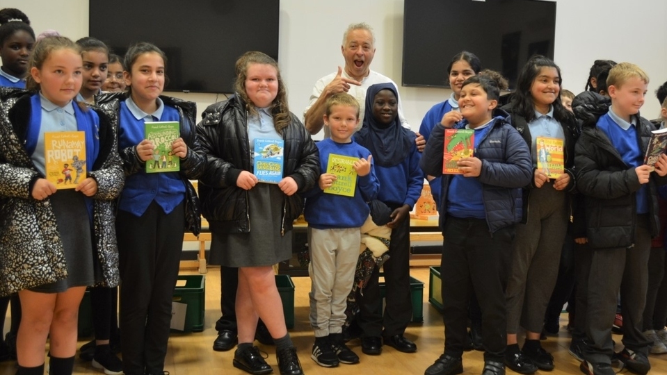 Frank Cottrell-Boyce is pictured with some of the Harmony Trust children Frank Cottrell-Boyce is pictured with some of the Harmony Trust children