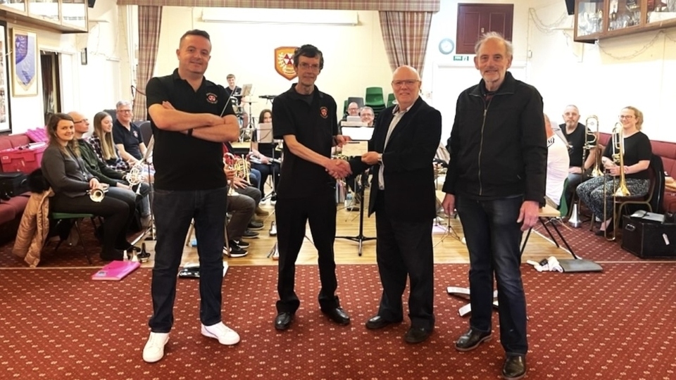 Community Chairman Jon Stocker and President Ian Brett, right, from Saddleworth Rotary, present a cheque to Band Chairman Andy Black and Musical Director Jason Smith Community Chairman Jon Stocker and President Ian Brett, right, from Saddleworth Rotary, present a cheque to Band Chairman Andy Black and Musical Director Jason Smith