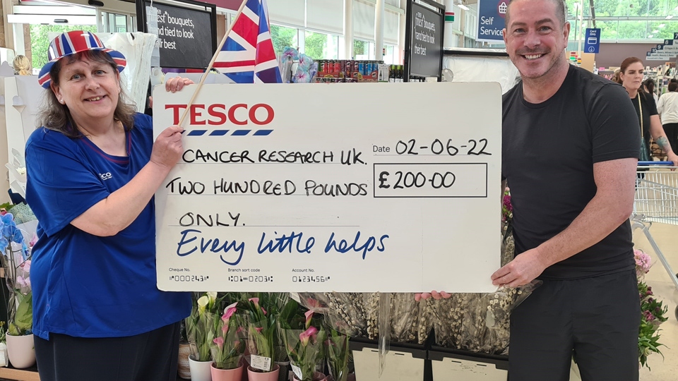 Tesco assistant Jackie Meyrick presented £200 to Cancer Research UK raised from the Greenfield store customer Library Tesco assistant Jackie Meyrick presented £200 to Cancer Research UK raised from the Greenfield store customer Library