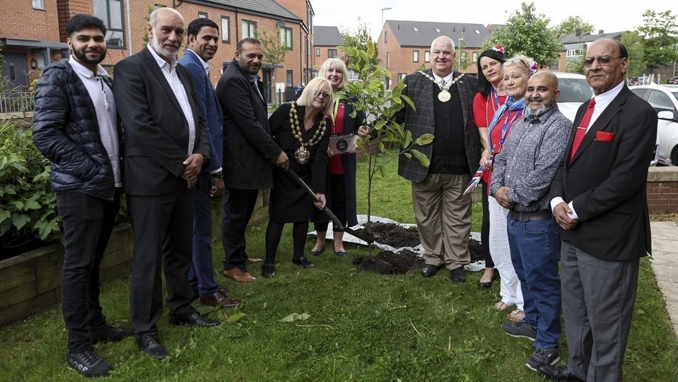 Cllr Elaine Garry, Mayor of Oldham (centre), is joined by guests to plant a magnolia tree at the Primrose Bank Community Centre to mark the Queen’s Platinum Jubilee