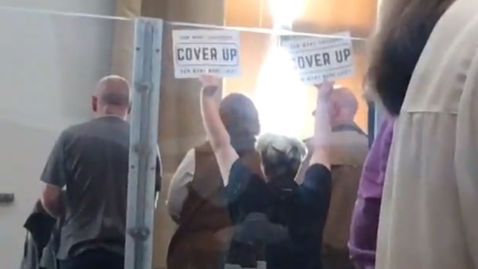 Members of the public waved signs that said 'cover up' at a recent meeting of the council convened to discuss the findings of the CSE report Members of the public waved signs that said 'cover up' at a recent meeting of the council convened to discuss the findings of the CSE report