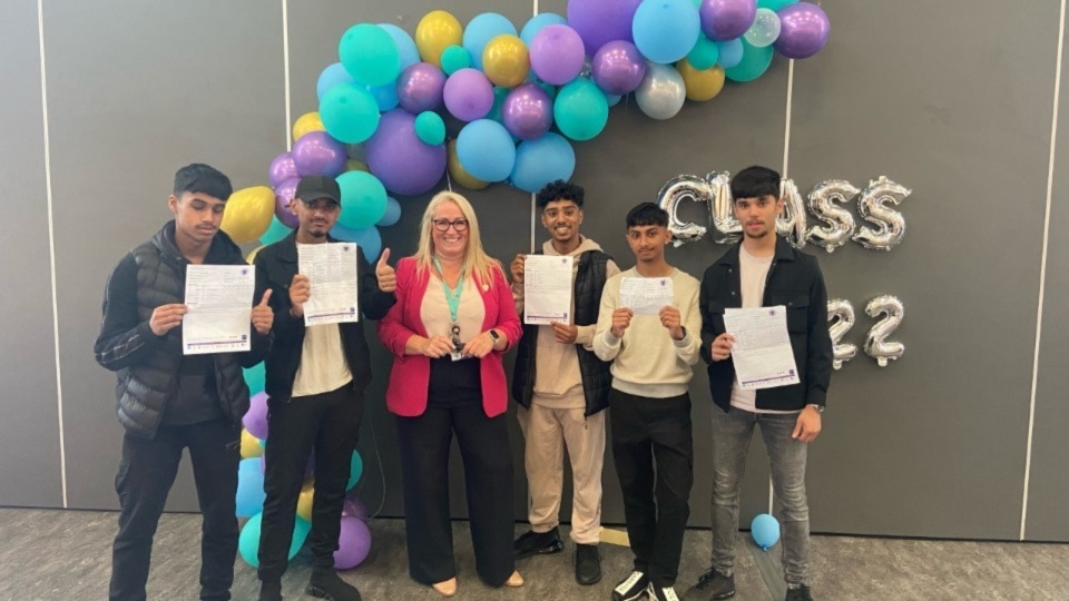 The Oldham Academy North Headteacher Rachael Hallam with some of her delighted students this morning