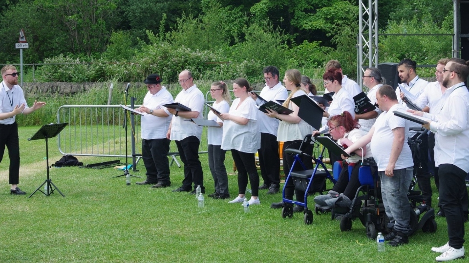 Pennine Mencap's very own Rhodes Bank Choir are pictured performing at this year's Saddleworth Show