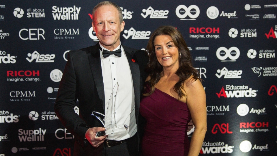 Steve Hill receives his award from Elaine Berry, Senior Divisional Operations Manager - North West, CER. They are the sponsor of the Teacher of the Year category at the Educate Awards