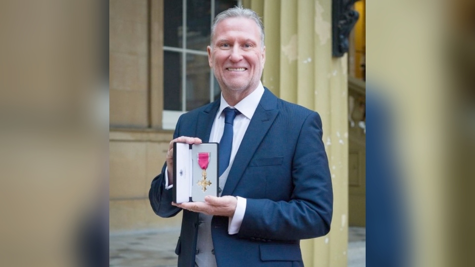 Graham Quinn, the CEO at the Oldham-based New Bridge Multi Academy Trust, pictured with his OBE at Buckingham Palace