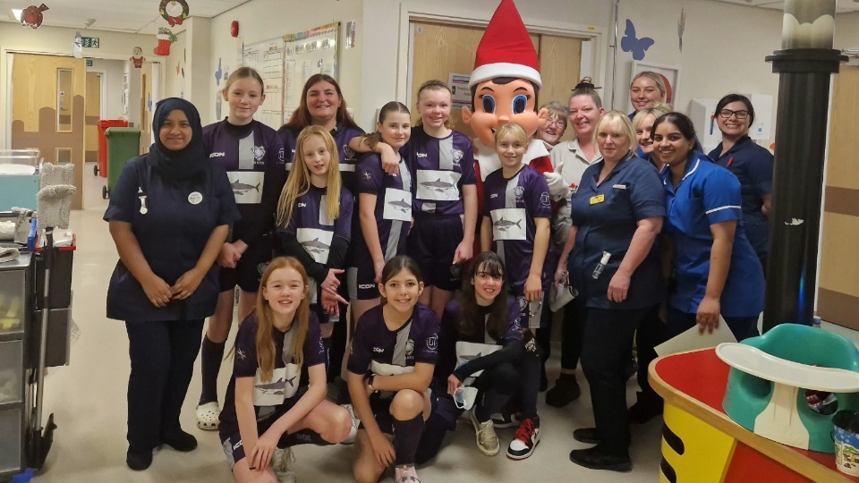 The Santos Sharks under-12s girls' football team party are pictured at the hospital