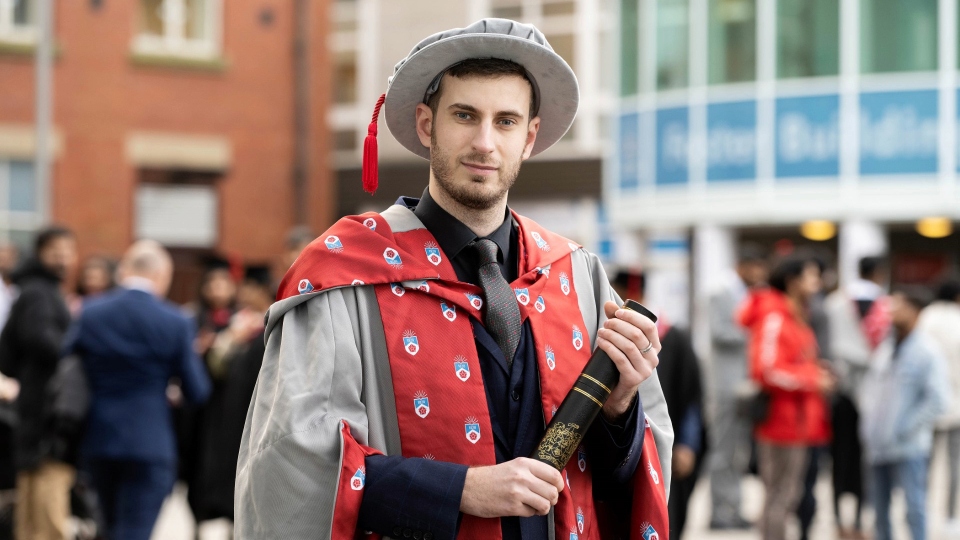 New University of Central Lancashire doctorate Steven Gough-Kelly in his PhD cap and gown