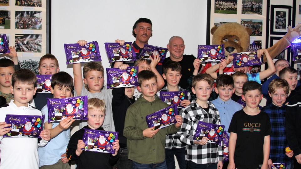 Pictured are the Saddleworth Rangers under-eights squad with Roary the Roughyed, John Davies and Samuel Doyle from the Roughyeds