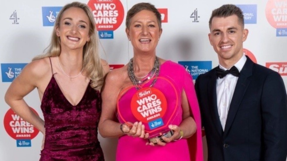 Max Whitlock and Amy Conroy present Jo with the award for the National Lottery Local Health Hero. Image courtesy of Arthur Edwards (The Sun)