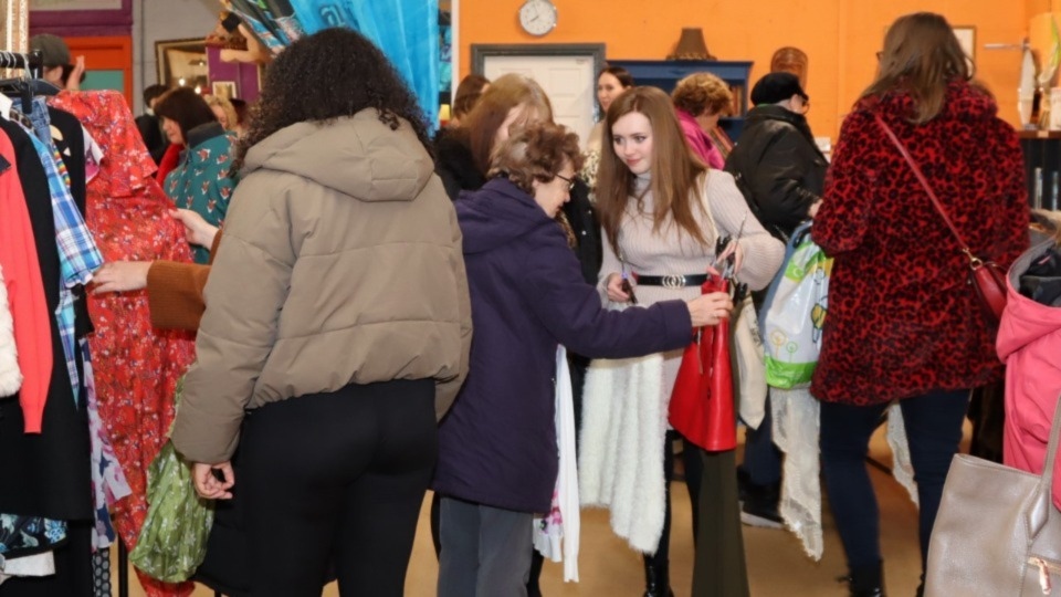 Guests sift through the rails at Emmaus Mossley's fashion show. Image courtesy of Phil Grainger