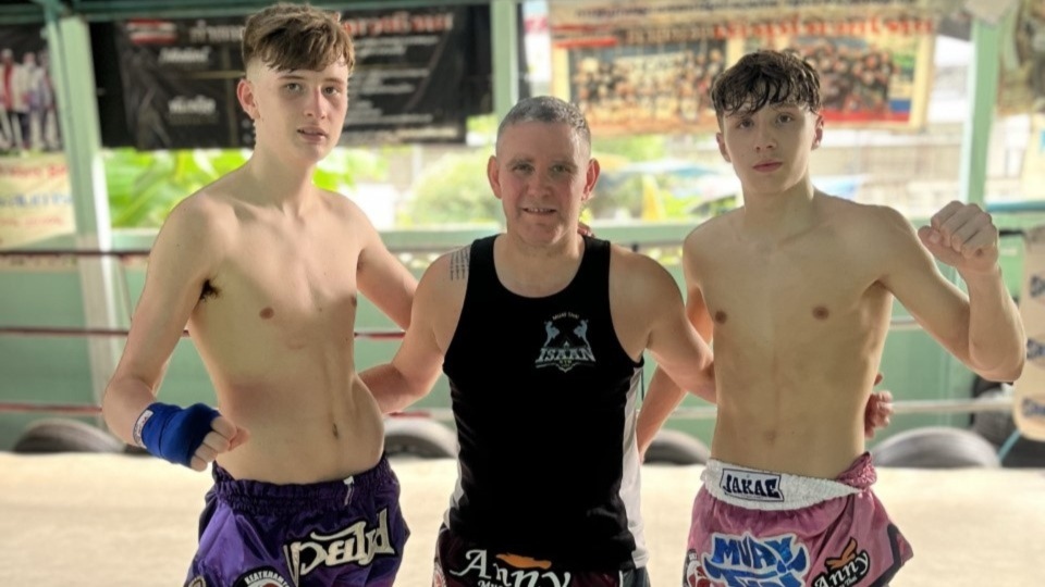 Gold medallists Tommy Lowe and Brayden Watson are pictured with Isaan Gym head coach Ste Donnelly