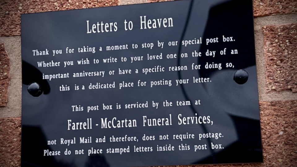 The plaque above the Farrell-McCartan Funeral Service 'Postbox to Heaven'
