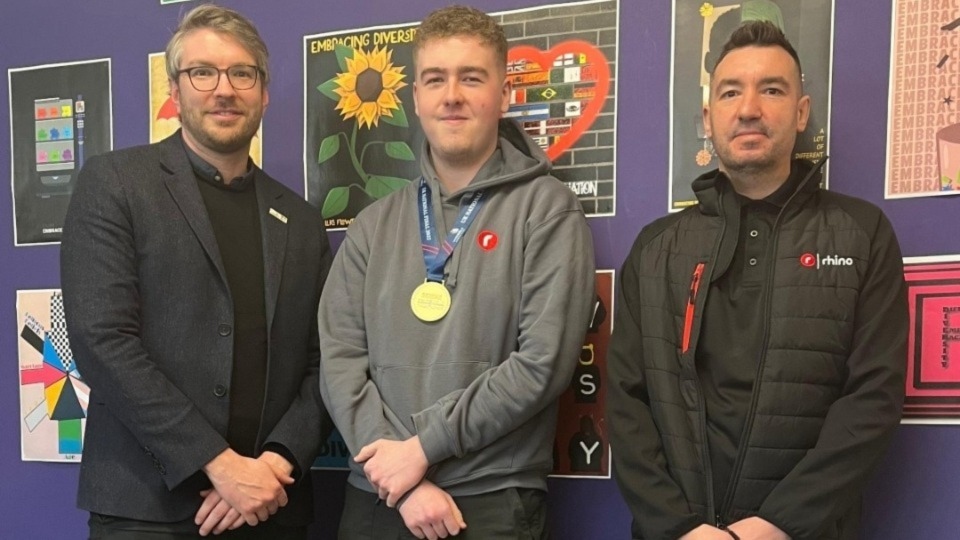 Ben Blackledge, Interim CEO of WorldSkills UK, is pictured with Joseph Brooks, Graphic Design Apprentice at Oldham College and Gold Medal winner 2022, and his employer, Lee Morris of Rhino Group