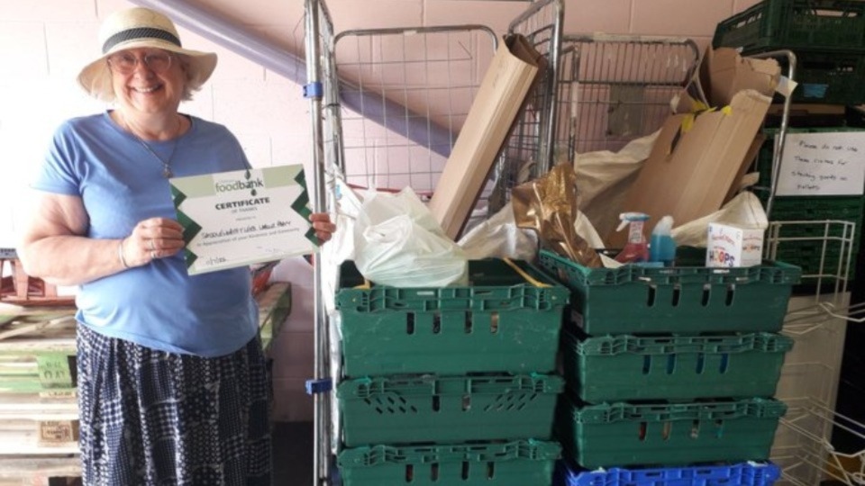 Hannah Roberts with the certificate acknowledging the donation of food to Oldham Foodbank following Tea for Trussell in 2022