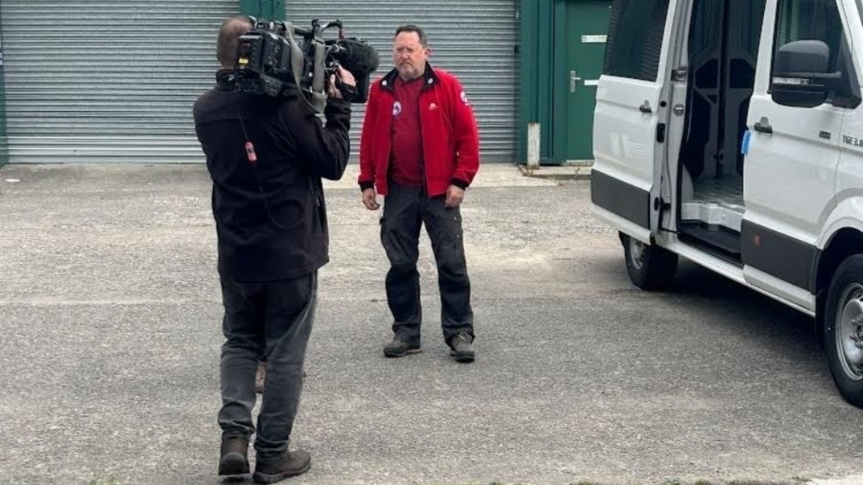 Oldham mountain rescue team member Justin Parkinson with a member of the BBC film crew