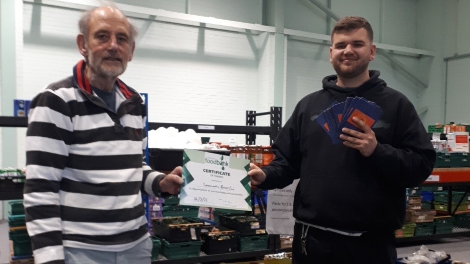Saddleworth Rotary Club President Ian Brett and Oldham Foodbank Manager Tom Lewis-Hood accepting £500 worth of Aldi vouchers on behalf of the Foodbank just a fortnight ago