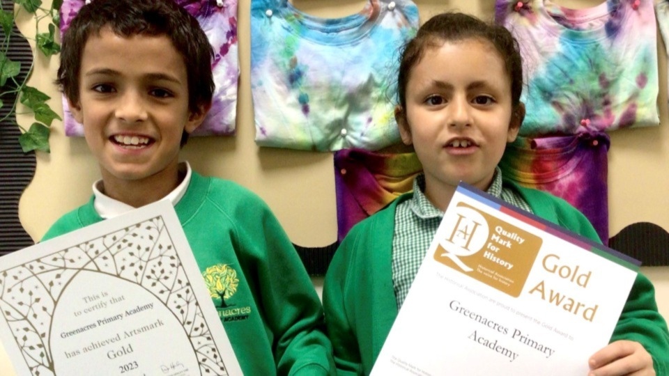 Greenacres Primary Academy pupils show off the school's certificates