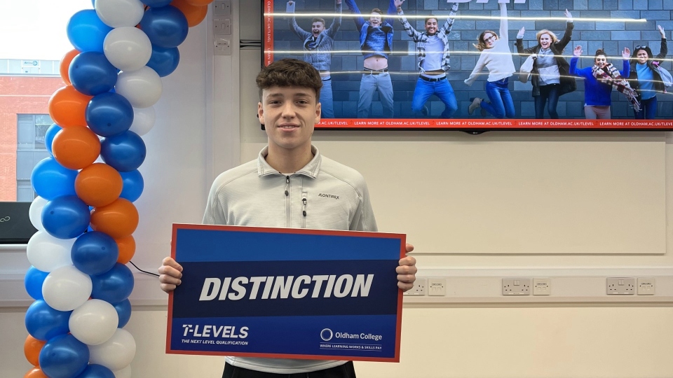 Oldham College student Joe Davies celebrating his Distinction grade in the  Construction - Design, Surveying and Planning T Level