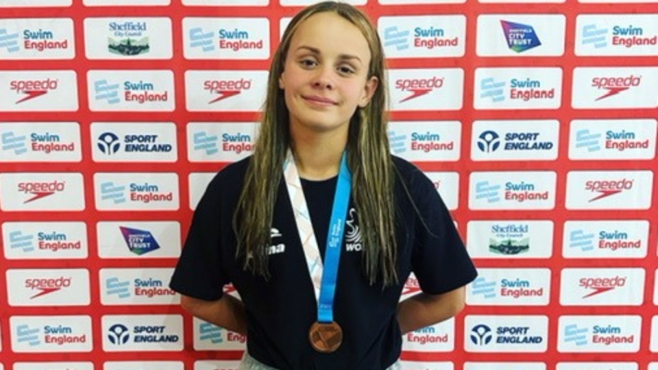 Autum Claxton shows off her bronze medal