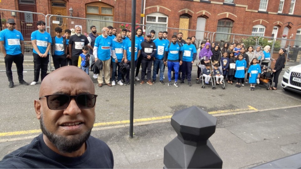 'Running Man' Afruz Miah with the group of walkers who set off from the scene of the devastating fire on Saint Thomas Street North