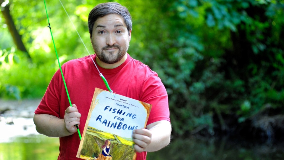 Oliver Sykes with his Fishing for Rainbows book. Image courtesy of Dawn Kilner