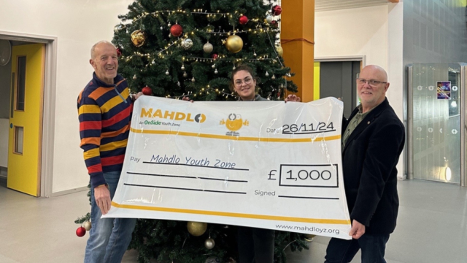 Saddleworth Rotary President Clint Elliott and Club Community Champion Jon Stocker are pictured presenting Mahdlo Events Lead Elizabeth Kershaw with a cheque for £1,000 Saddleworth Rotary President Clint Elliott and Club Community Champion Jon Stocker are pictured presenting Mahdlo Events Lead Elizabeth Kershaw with a cheque for £1,000