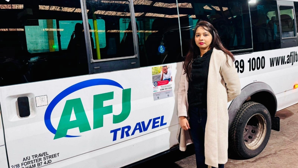 Pooja Sharma shows the flyer on one of the AFJ coaches