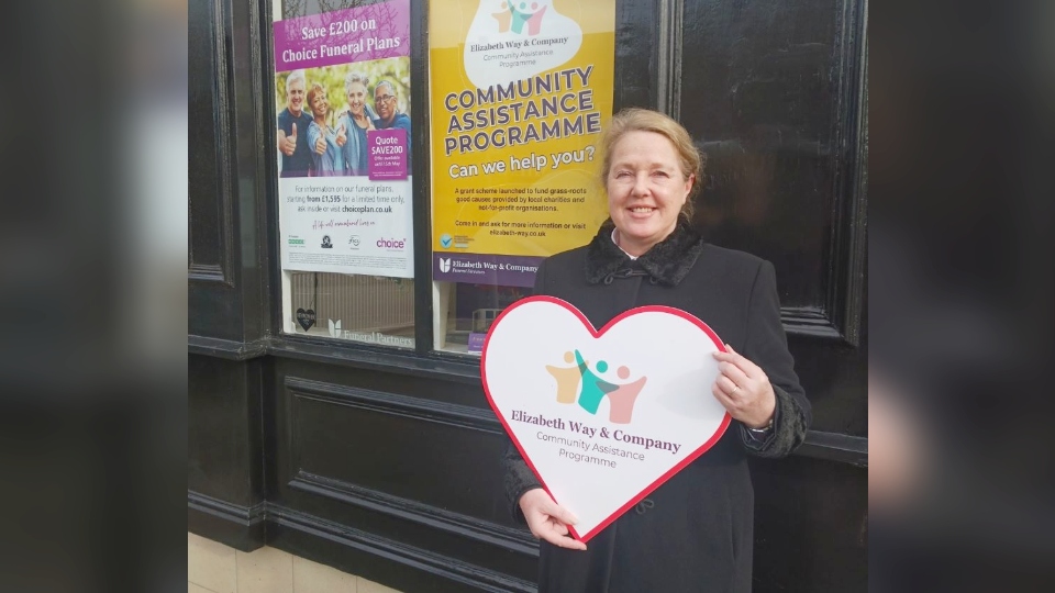 Funeral Director Pauline Lawrence outside Elizabeth Way and Company Funeral Directors in Stamford Street, Mossley