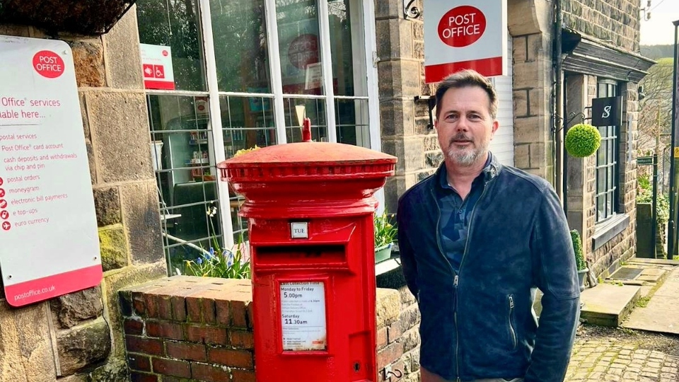 Nathan Beckwith pictured outside Dobcross Post Office and Village Store