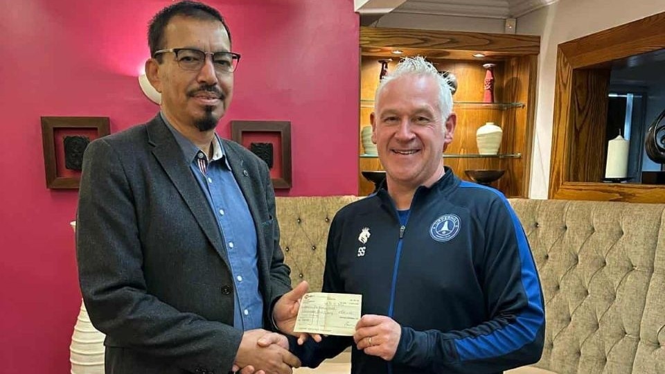 Uppermill FC Chief Executive Steve Southern is pictured with the owner of The Shalimar, Mr Mohammad Abdul Hannan