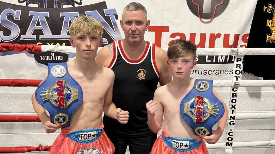 Isaan Head Coach Ste Donnelly is pictured (centre) with two of his young fighters Isaan Head Coach Ste Donnelly is pictured (centre) with two of his young fighters