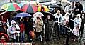 IT’S CHRISTMAS TIME... and umbrella time: over 70 people braved the rain to sing carols in Uppermill 