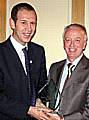 Pete receives the award from Trevor Massey