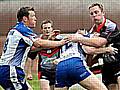 FORWARDS BATTLE: Jason Boults (right) is held 