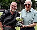 Stan Boston of Crompton receives the trophy from chairman Bryan O'Neill (left).