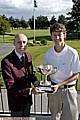 Chris Rabbich (right) receives the trophy from Werneth captain David Whittingham. 