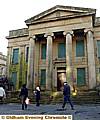 Boarded up . . . green and decaying, the town hall today 
